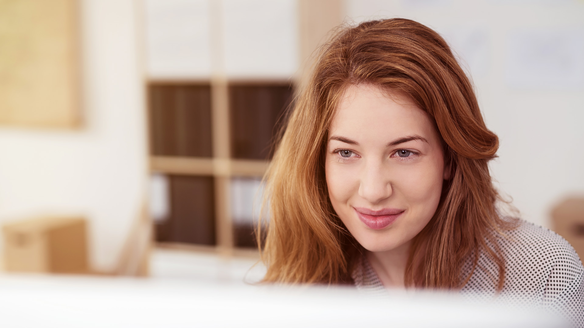 Woman smiling using computer